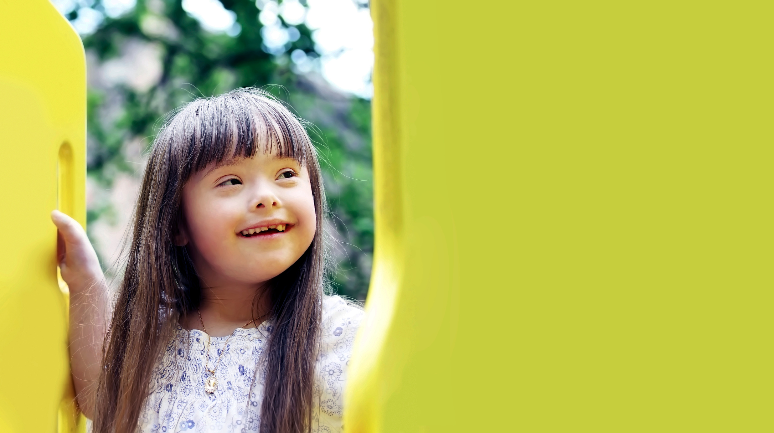 Young Girl with Down Syndrome at a Playground